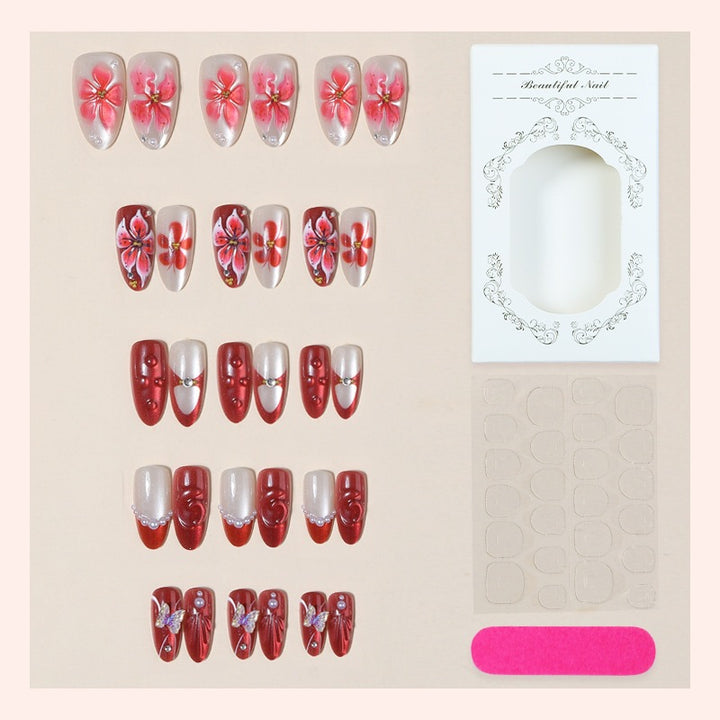 Artificial nail set with floral designs and glamorous accents Bowlift