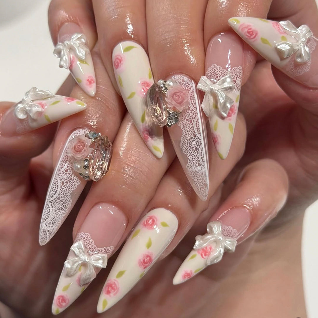 Artful stiletto nails with floral accents and glitter accents Bowlift