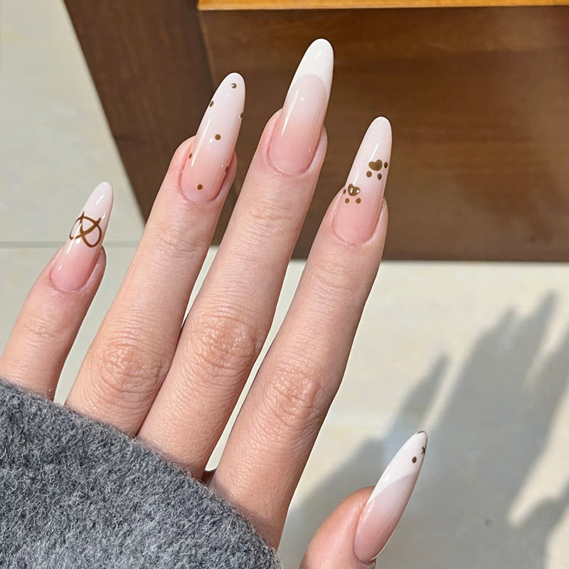 Glamorous Stiletto Press-On Nail Design with Elegant Gold Accents Bowlift