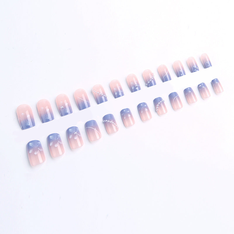 Nail set with elegant floral accents and glitter embellishments Bowlift