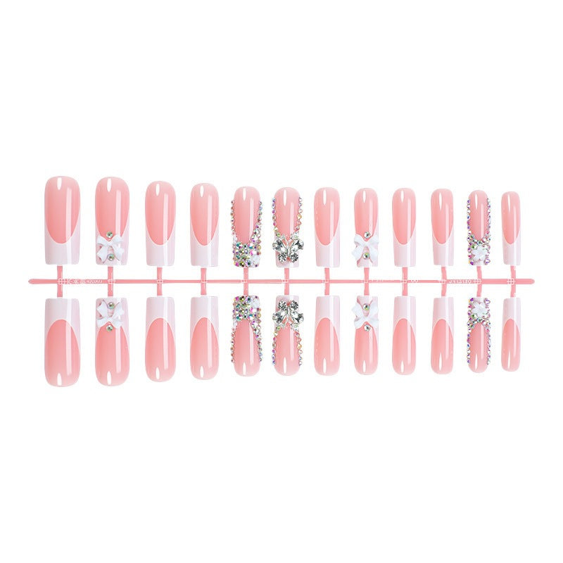 Artificial nail set with luxurious decorations and glitter accents Bowlift