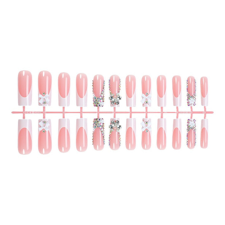 Artificial nail set with luxurious decorations and glitter accents Bowlift
