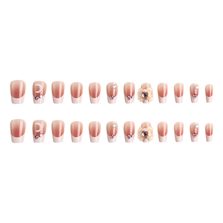 Artificial nail set with elegant floral decorations and glitter accents Bowlift