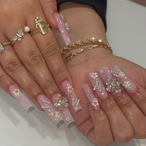 Artistic Nail Extensions with Glitter and Floral Accents Bowlift
