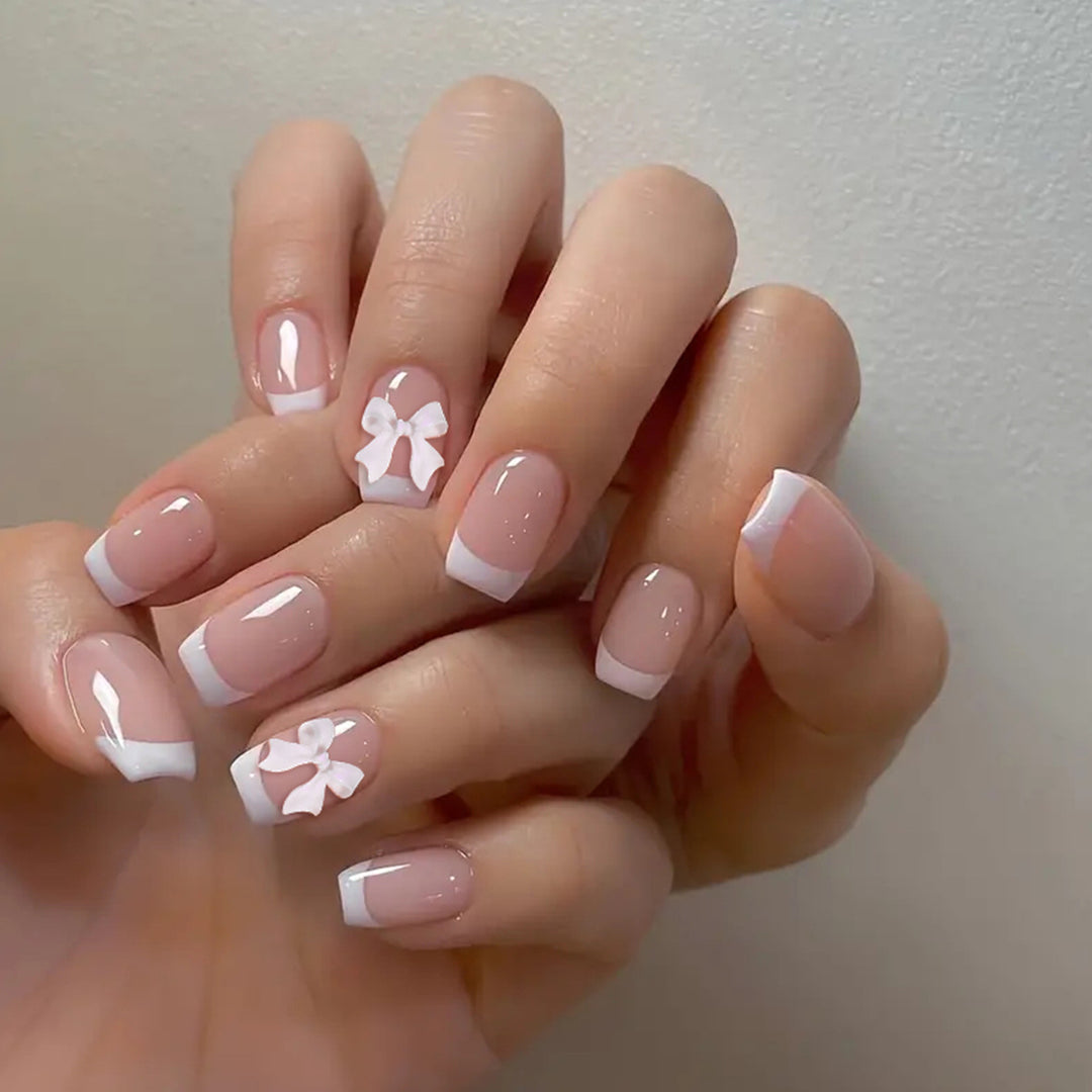Elegant French Tip Nail Art with Bow Embellishments Bowlift