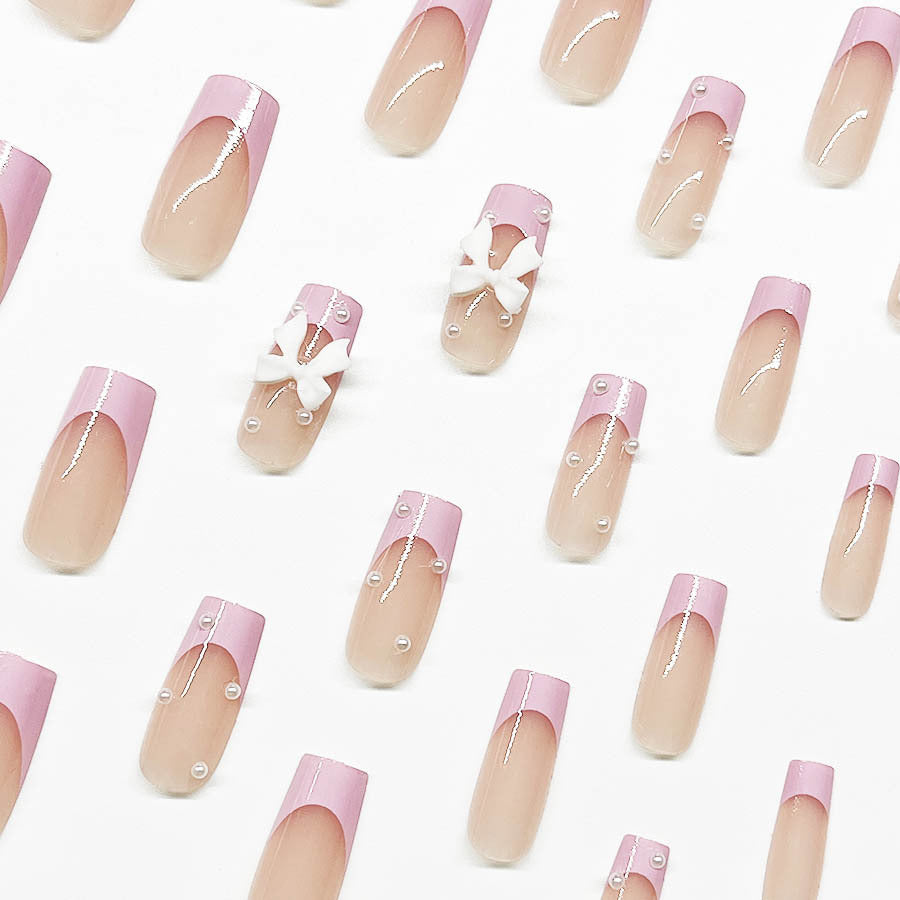 Artificial nail set with romantic bow and pearl embellishments Bowlift