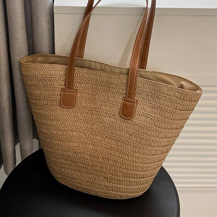 Stylish beach bag made of woven natural material with leather handles Bowlift