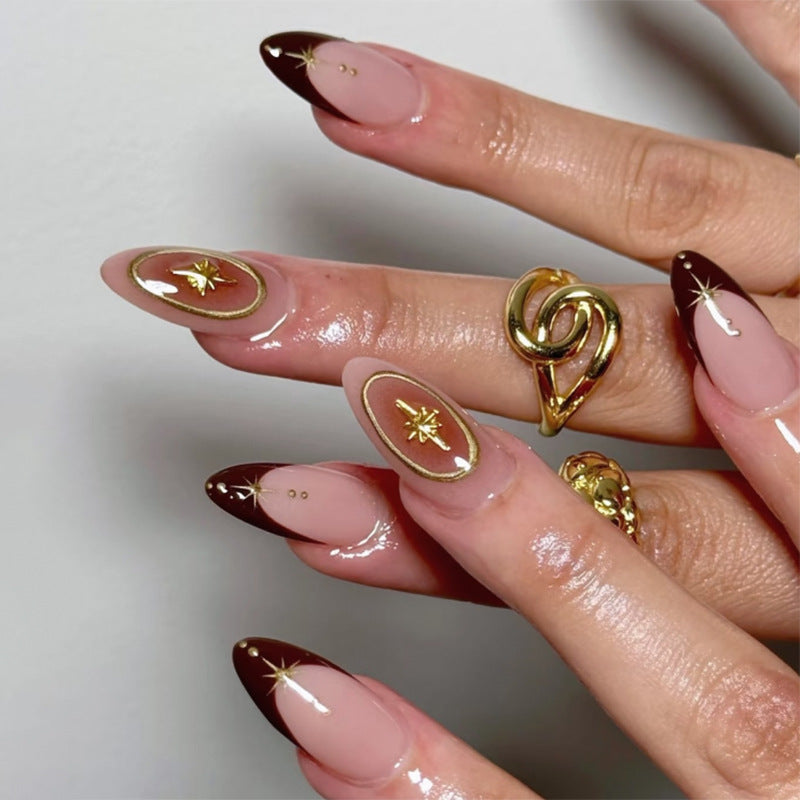 Artful stiletto nails with elegant gold embellishments Bowlift