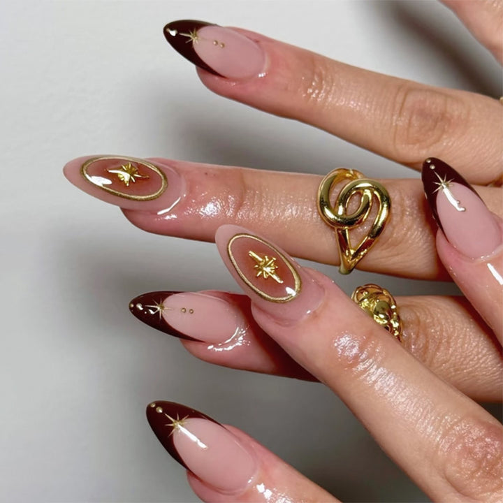 Artful stiletto nails with elegant gold embellishments Bowlift