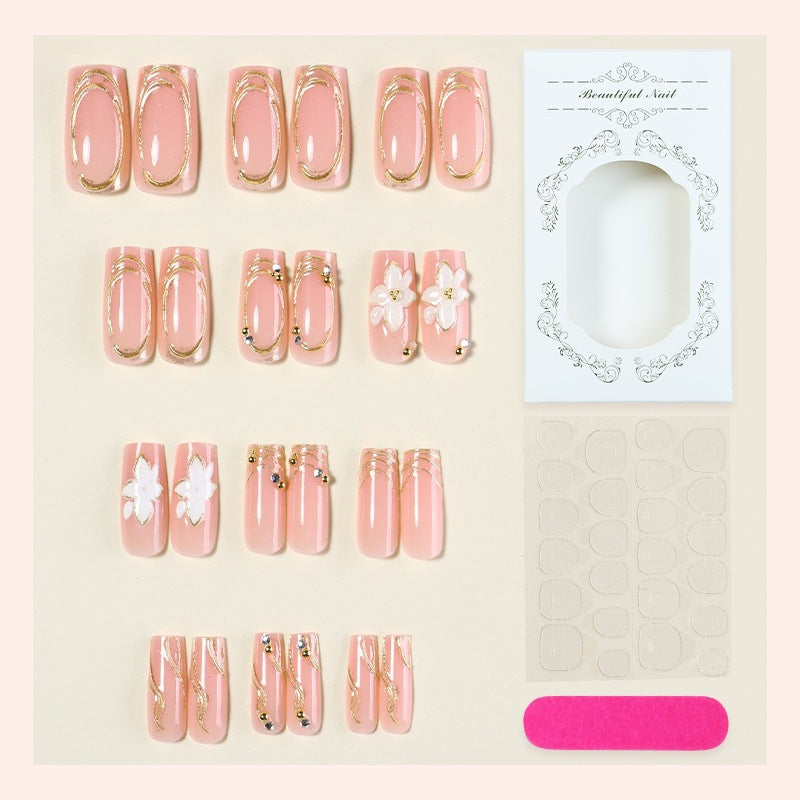 Elegant artificial nail set with decorative flower and gold embellishments Bowlift