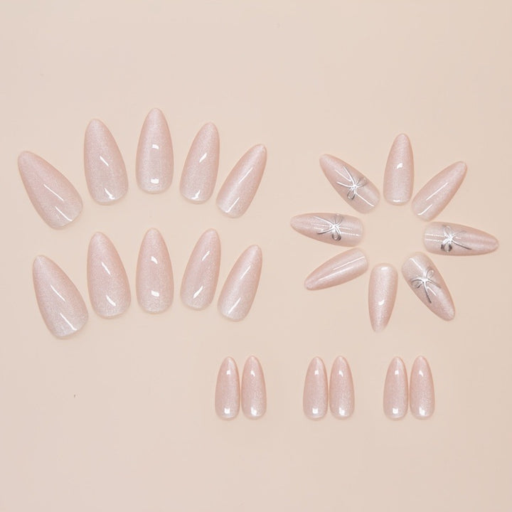Artificial nail set with delicate glitter and elegant bow decorations Bowlift