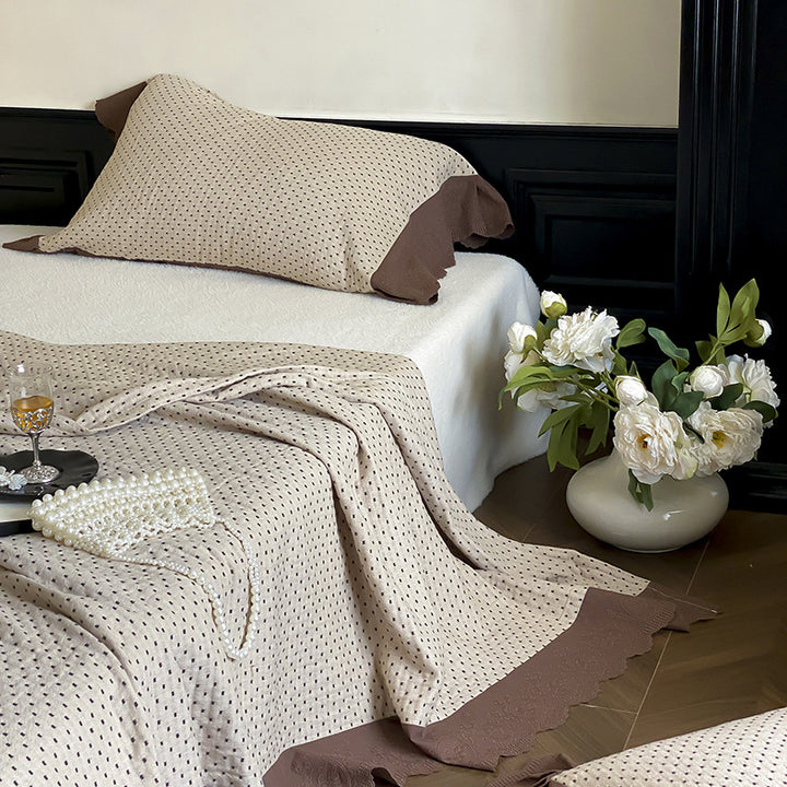 Quilted bedspread and pillowcase set with waffle texture and contrasting ruffle