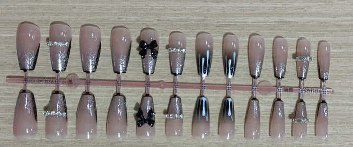 Elegant nail design with bow and rhinestone details Bowlift