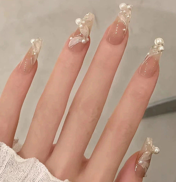 Elegant nail design with pearl embellishment Bowlift