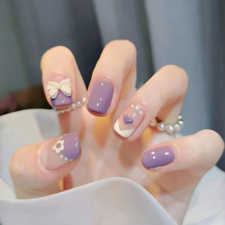 Artistic Nail Art with Glitter and Flower Applications Bowlift