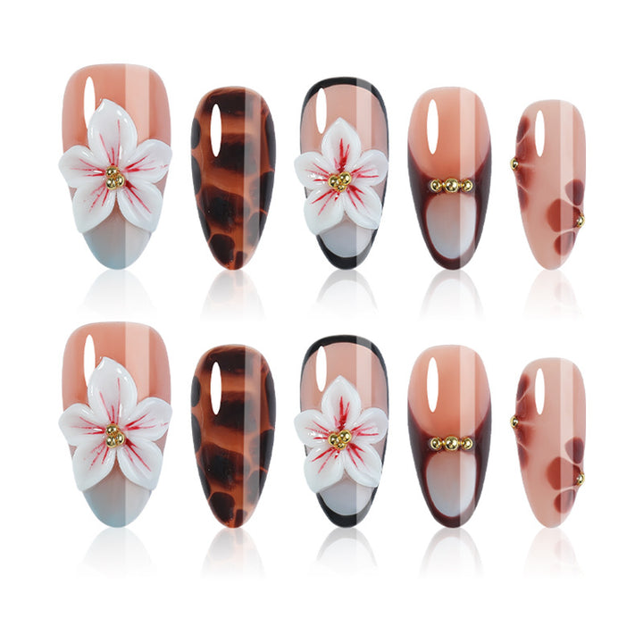Acrylic nail set with floral accents and elegant embellishments Bowlift