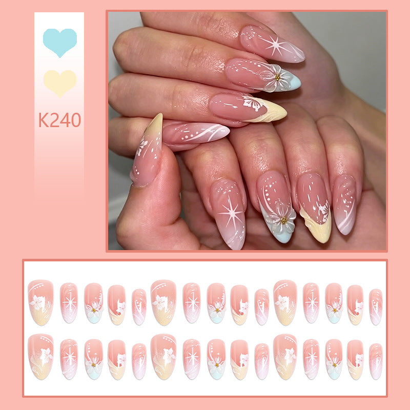 Artificial nail set with intricately detailed floral designs and shine accents Bowlift