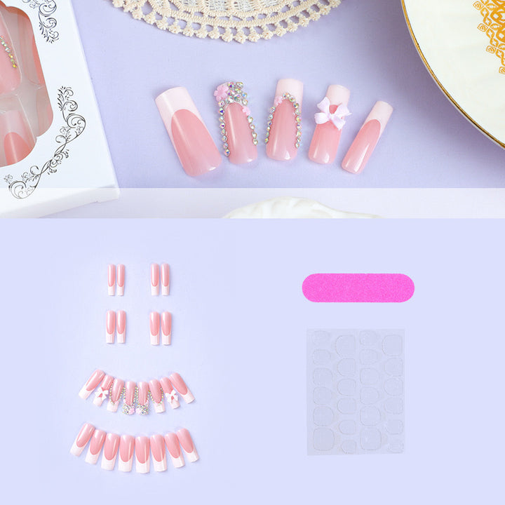 Artificial nail set with careful ribbon and glitter decorations Bowlift
