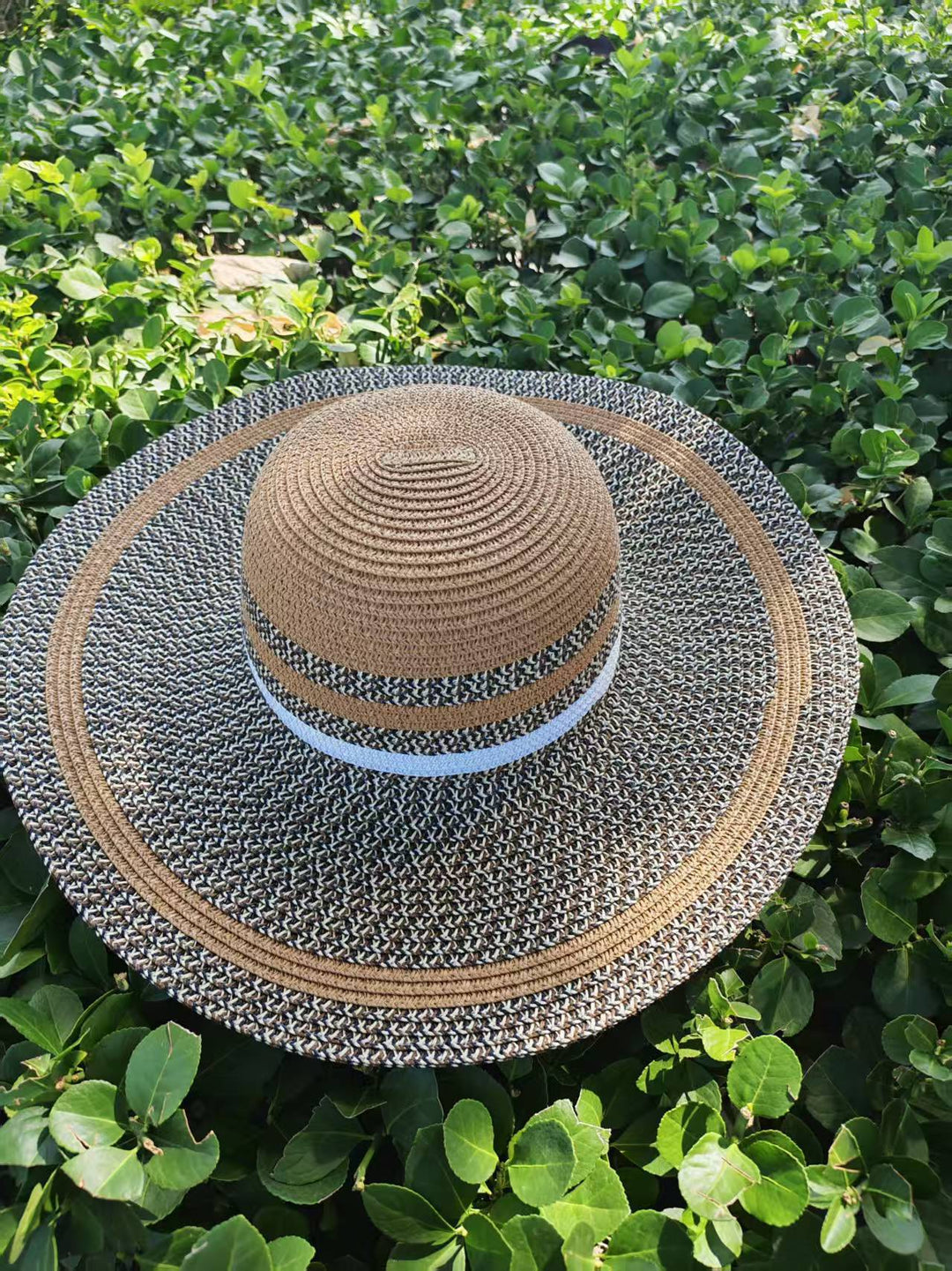 Elegant sun hat with wide brim and subtle stripe pattern Bowlift