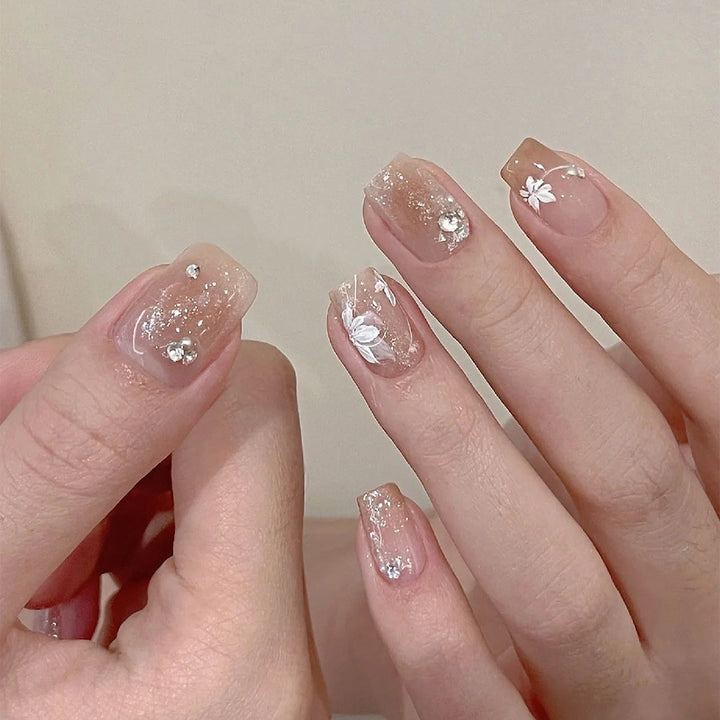 Elegant Nail Art with Holographic Accents and Floral Embellishments Bowlift
