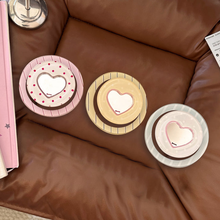 Heart-shaped coaster with playful design Bowlift