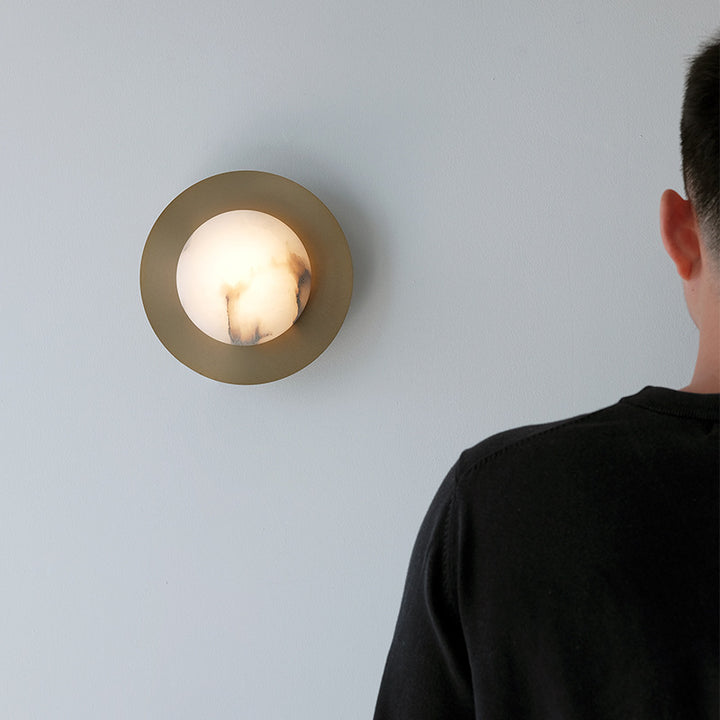 Contemporary alabaster globe wall sconce with round metal backplate Bowlift