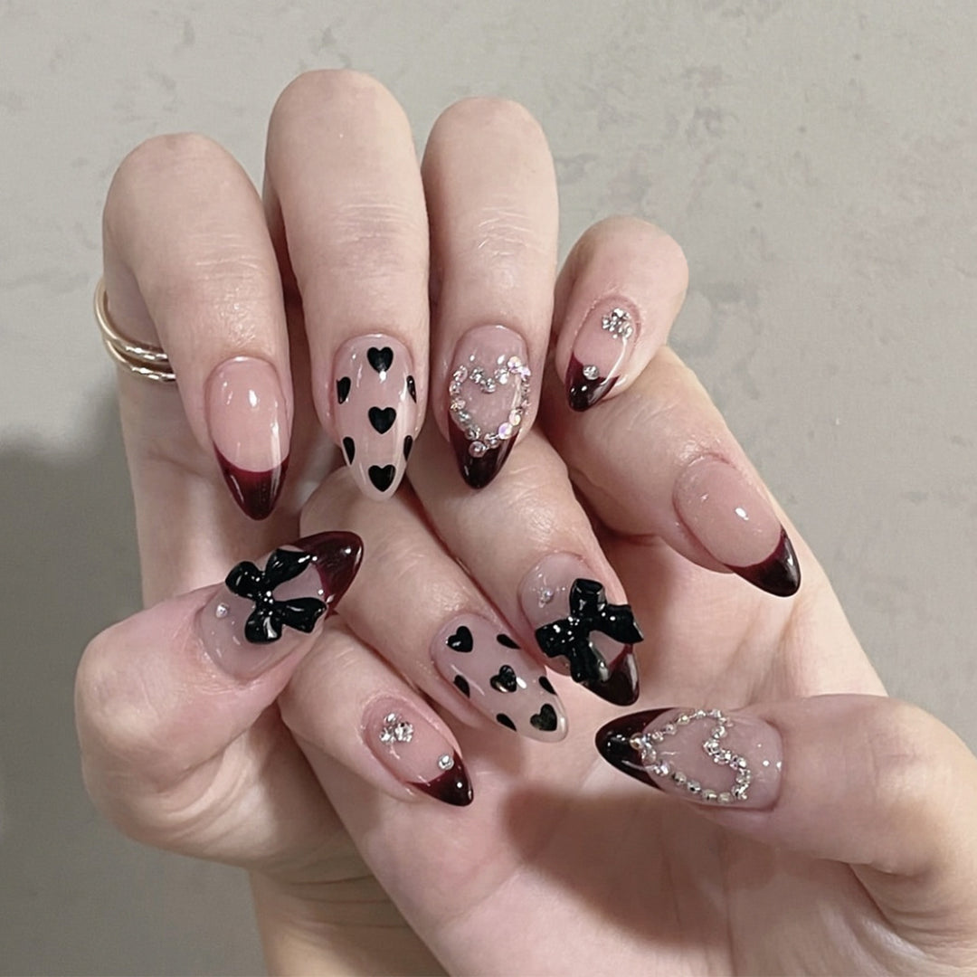 Artistic Stiletto Nail Art Extensions with Heart and Bow Accents Bowlift
