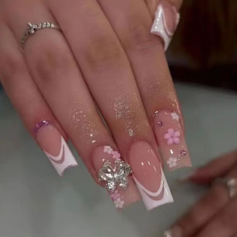 Artificial nails with floral accents and glitter effects Bowlift