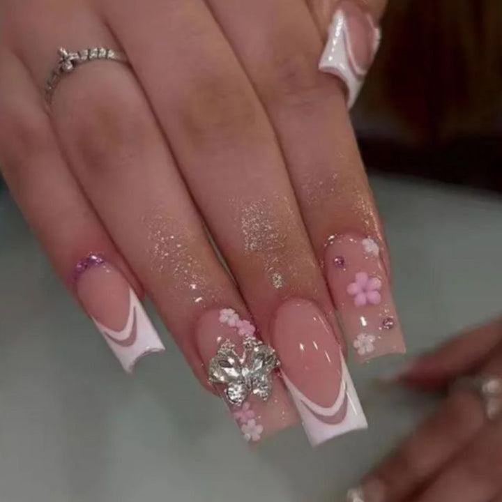 Artificial nails with floral accents and glitter effects Bowlift
