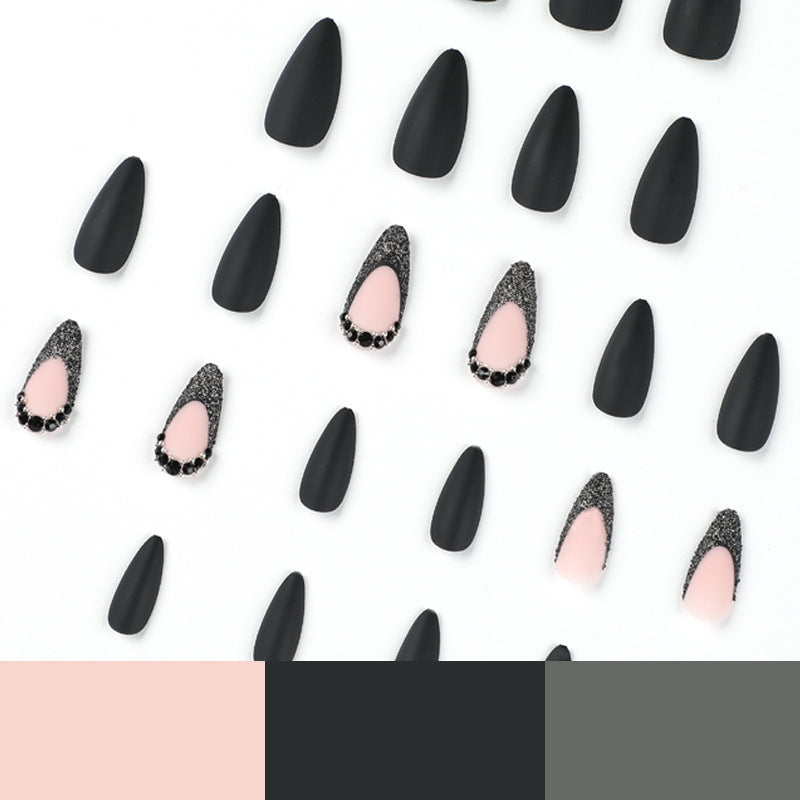 Artful stiletto nails with elegant black design and glitter accents Bowlift
