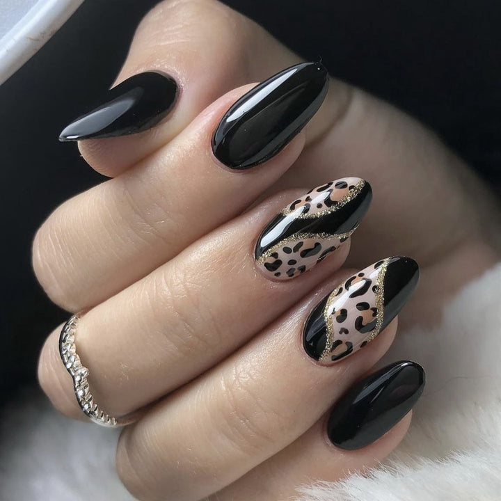Artistic stiletto nails with leopard design and glitter effects Bowlift