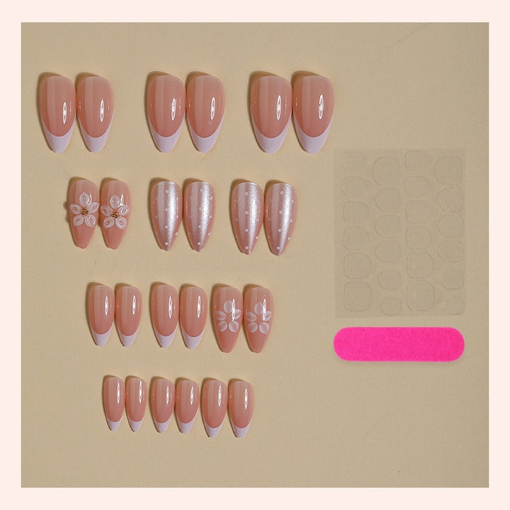 Artificial nail set with elegant French tips and delicate floral accents Bowlift