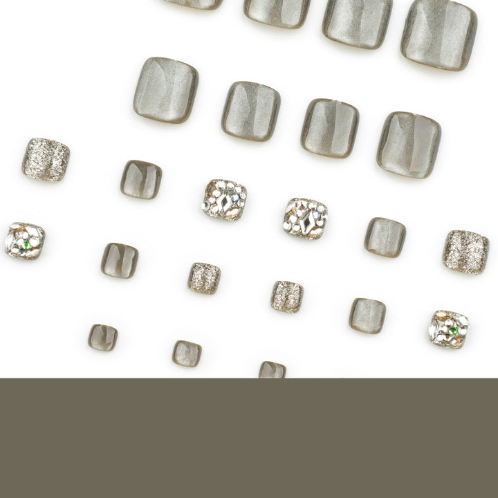 Artful toenail design with glitter and rhinestone decorations Bowlift