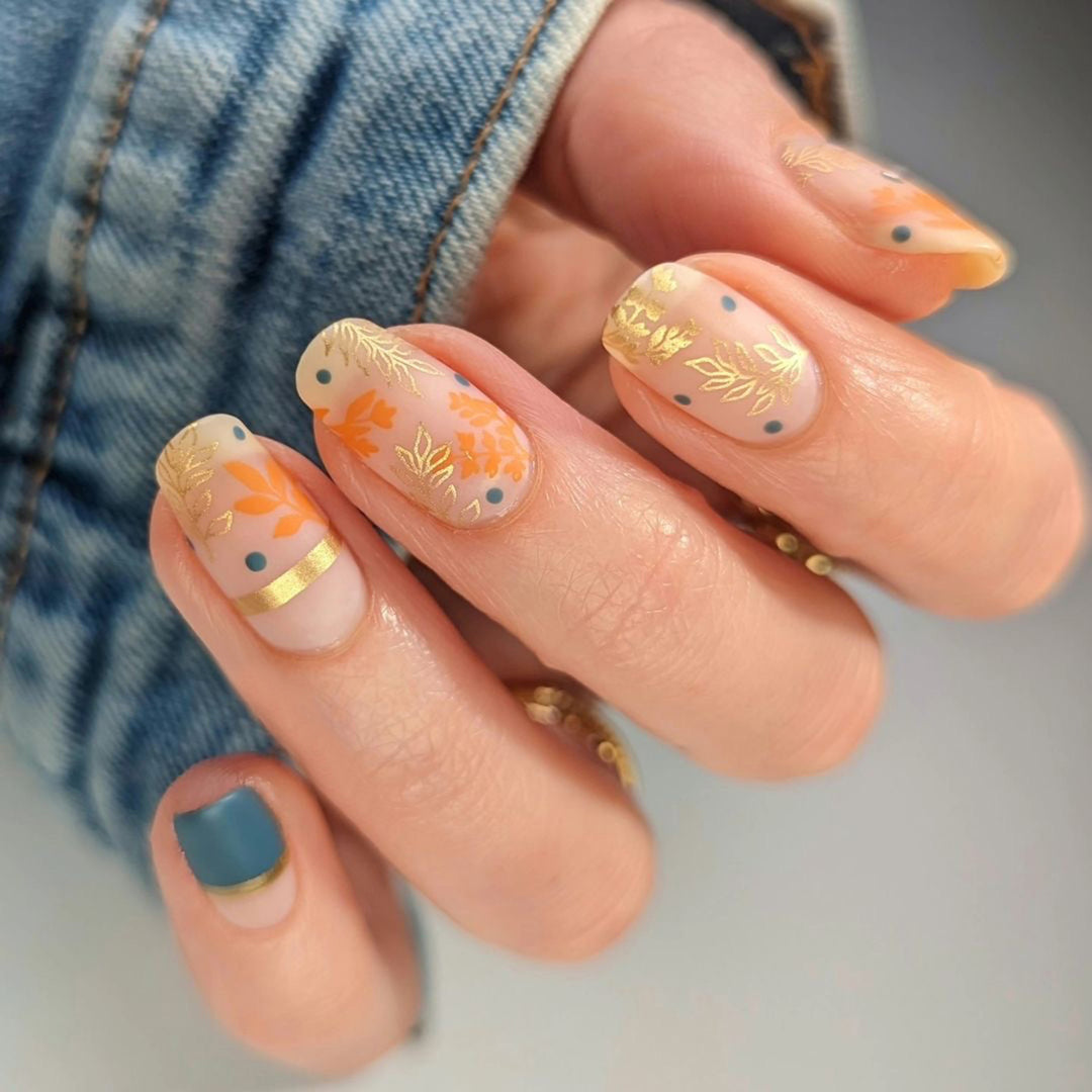 Artistic nail design with floral and golden accent Bowlift