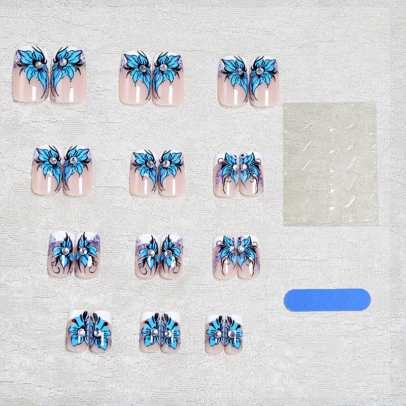 Artificial nail set with intricate floral designs and glitter elements Bowlift