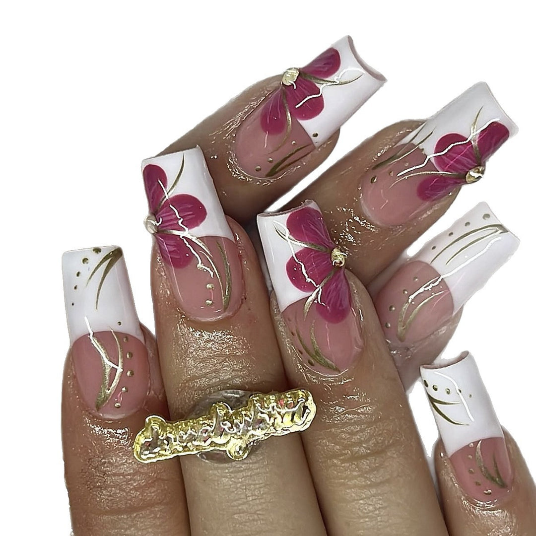 Artificial nail set with floral detail and glitter accents Bowlift