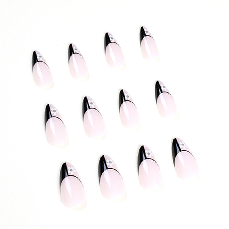 Artful nail art with elegant black-and-white design and floral accents Bowlift