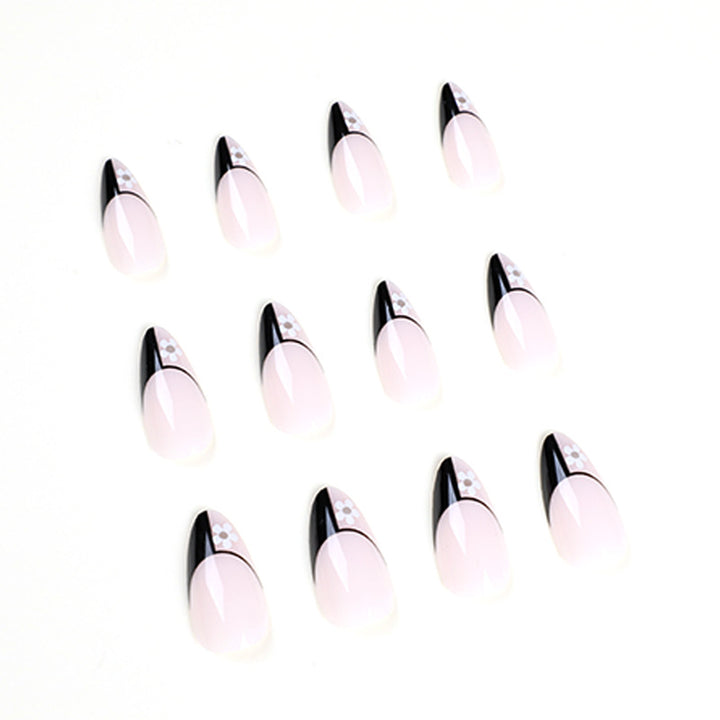 Artful nail art with elegant black-and-white design and floral accents Bowlift