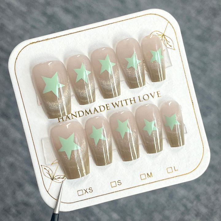 Artificial nail extensions with shimmer effect and star motifs Bowlift