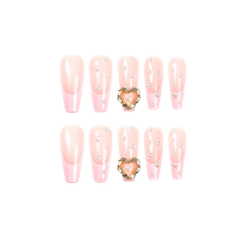 Artistic nail art with heart and pearl accents Bowlift