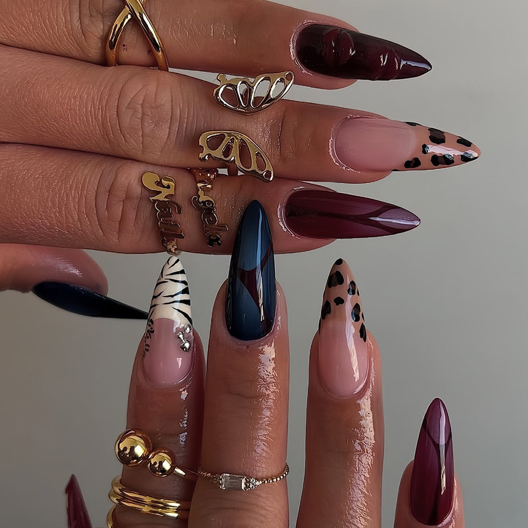 Artistic Stiletto Nail Enhancements with Trendy Animal Print and Gem Accents Bowlift