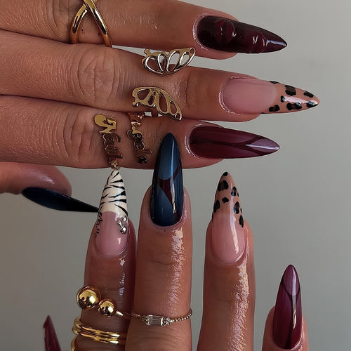 Artistic Stiletto Nail Enhancements with Trendy Animal Print and Gem Accents Bowlift