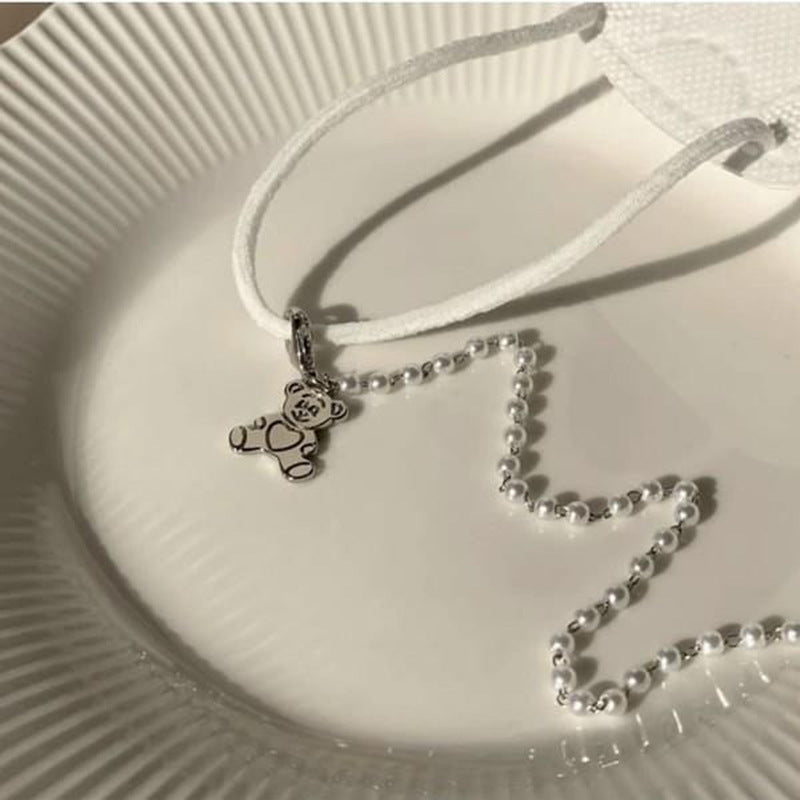 Playful pearl necklace with gold pendants Bowlift