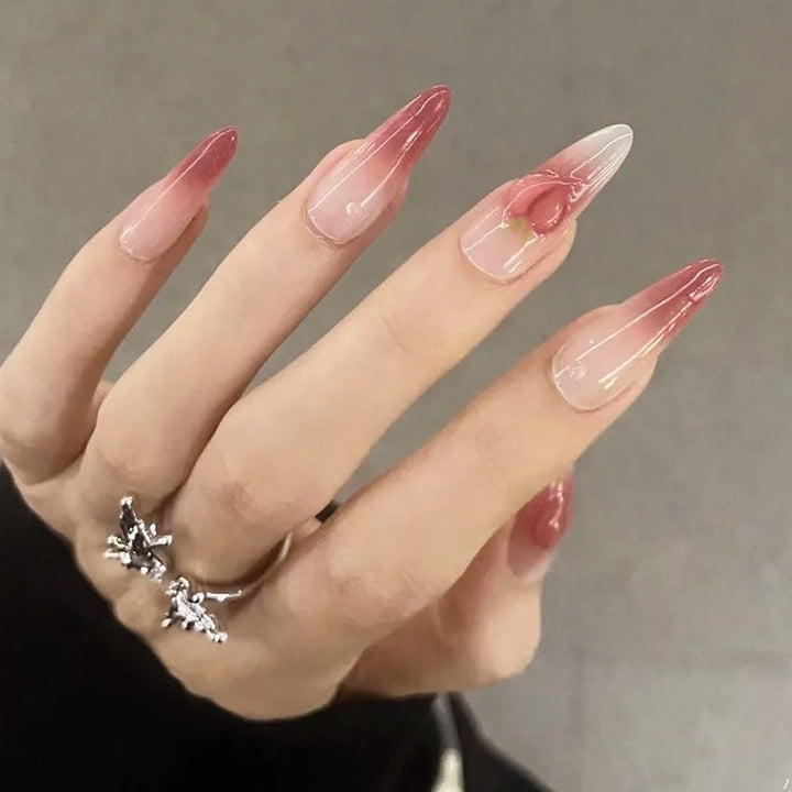 Nail set in elegant ombre design with artistic accents Bowlift