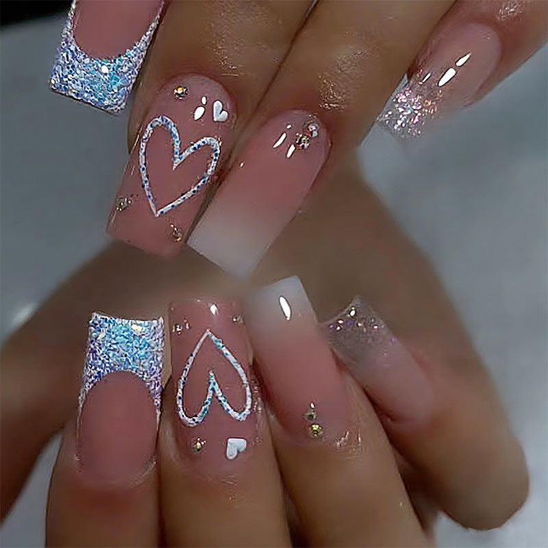 Artificial nails with sparkling heart designs and glitter details Bowlift
