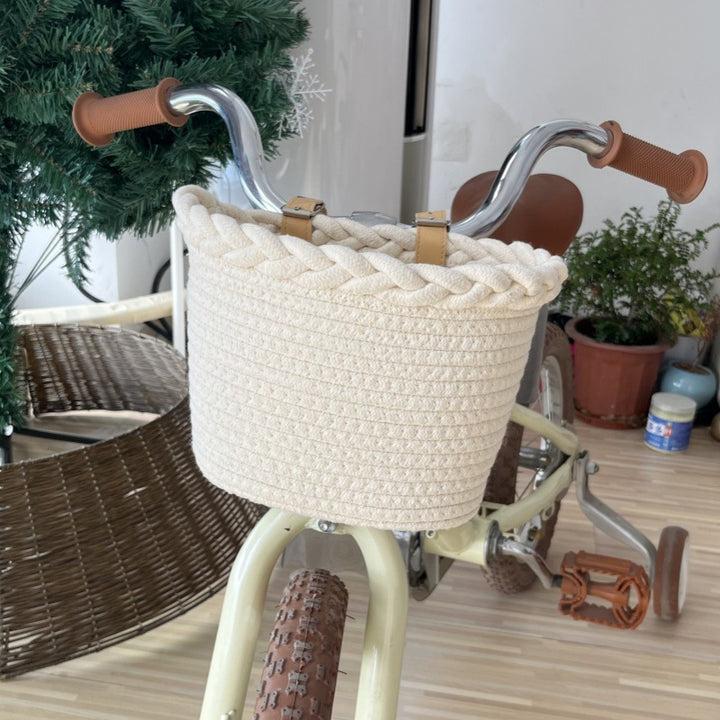 braided rope bike basket with pom pom embellishments and leather handlebar straps Bowlift