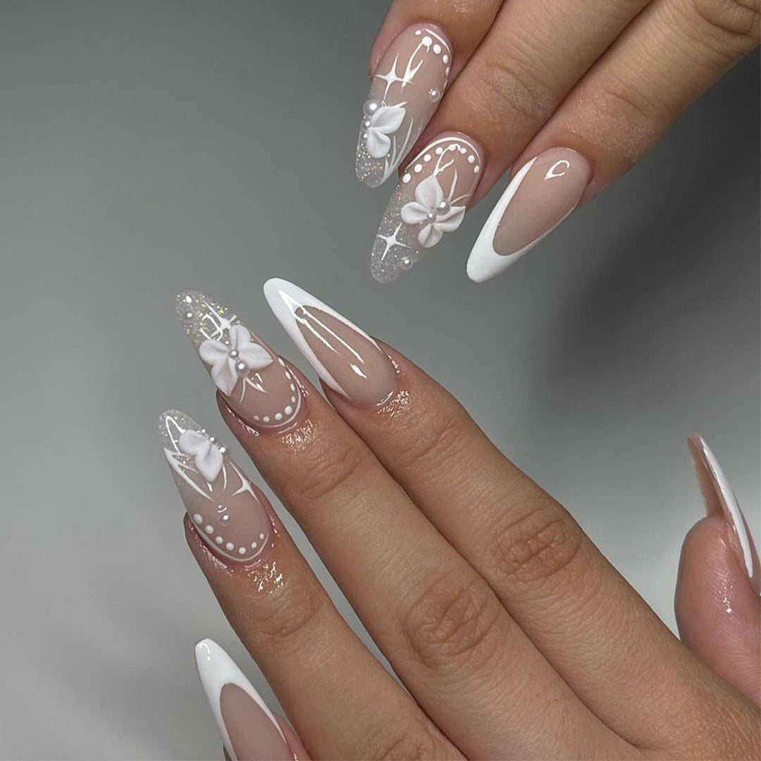 Artful stiletto nails with floral designs and glitter accents Bowlift