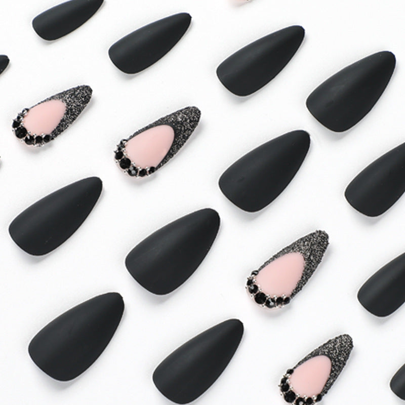 Artful stiletto nails with elegant black design and glitter accents Bowlift