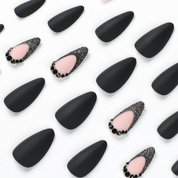Artful stiletto nails with elegant black design and glitter accents Bowlift