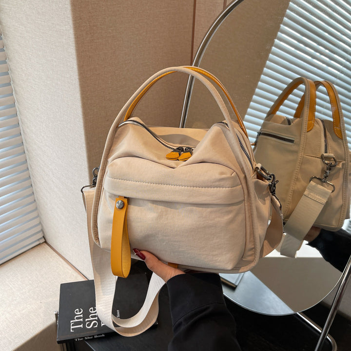 Fashionable shoulder bag with innovative structure and detachable carrying strap Bowlift